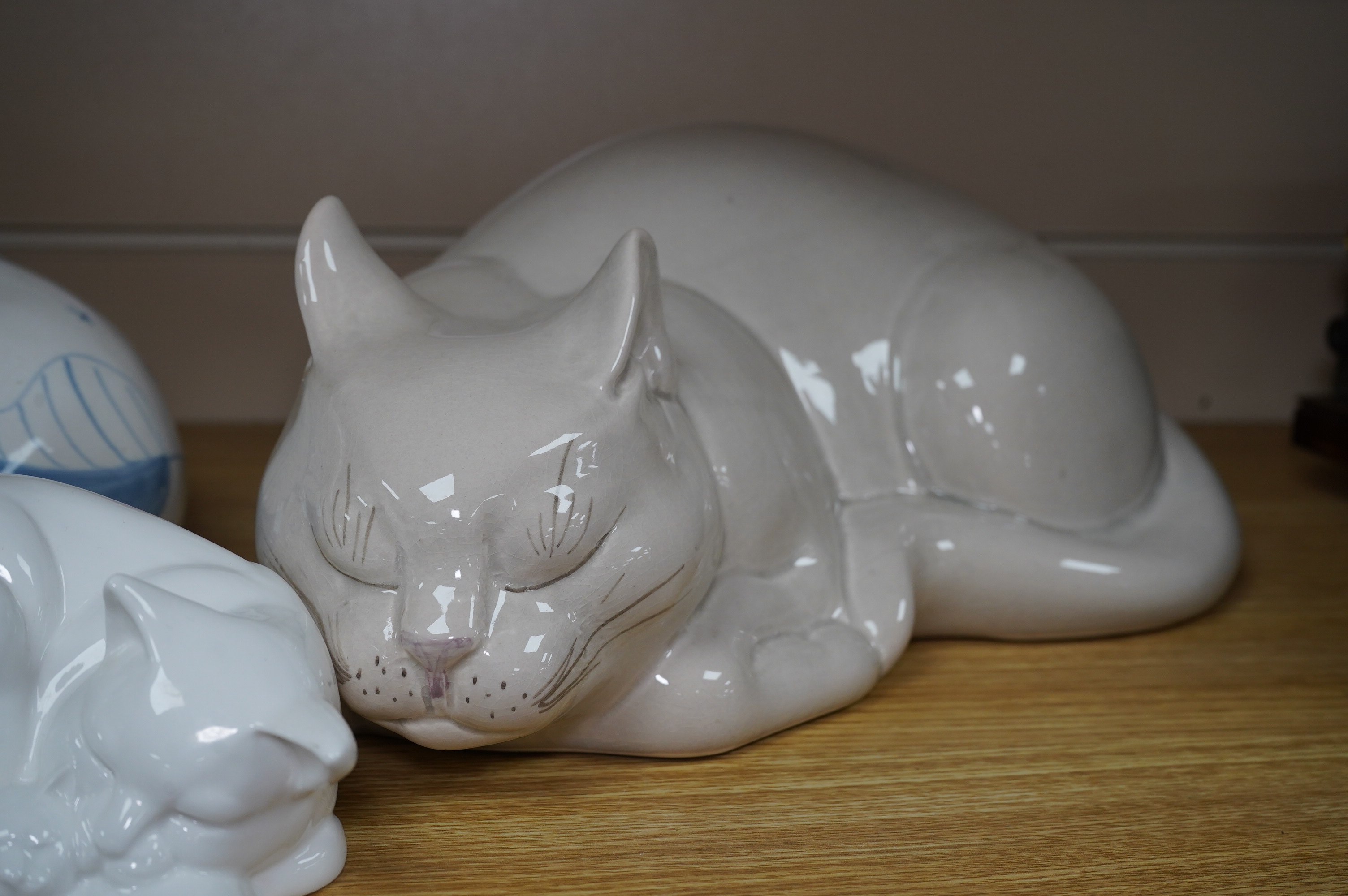 Three large David Sharp Rye pottery models of cats and a Moments by Coalport cat ‘Mothers Love’, tallest 18cm. Condition - largest cat with large firing crack to base otherwise good